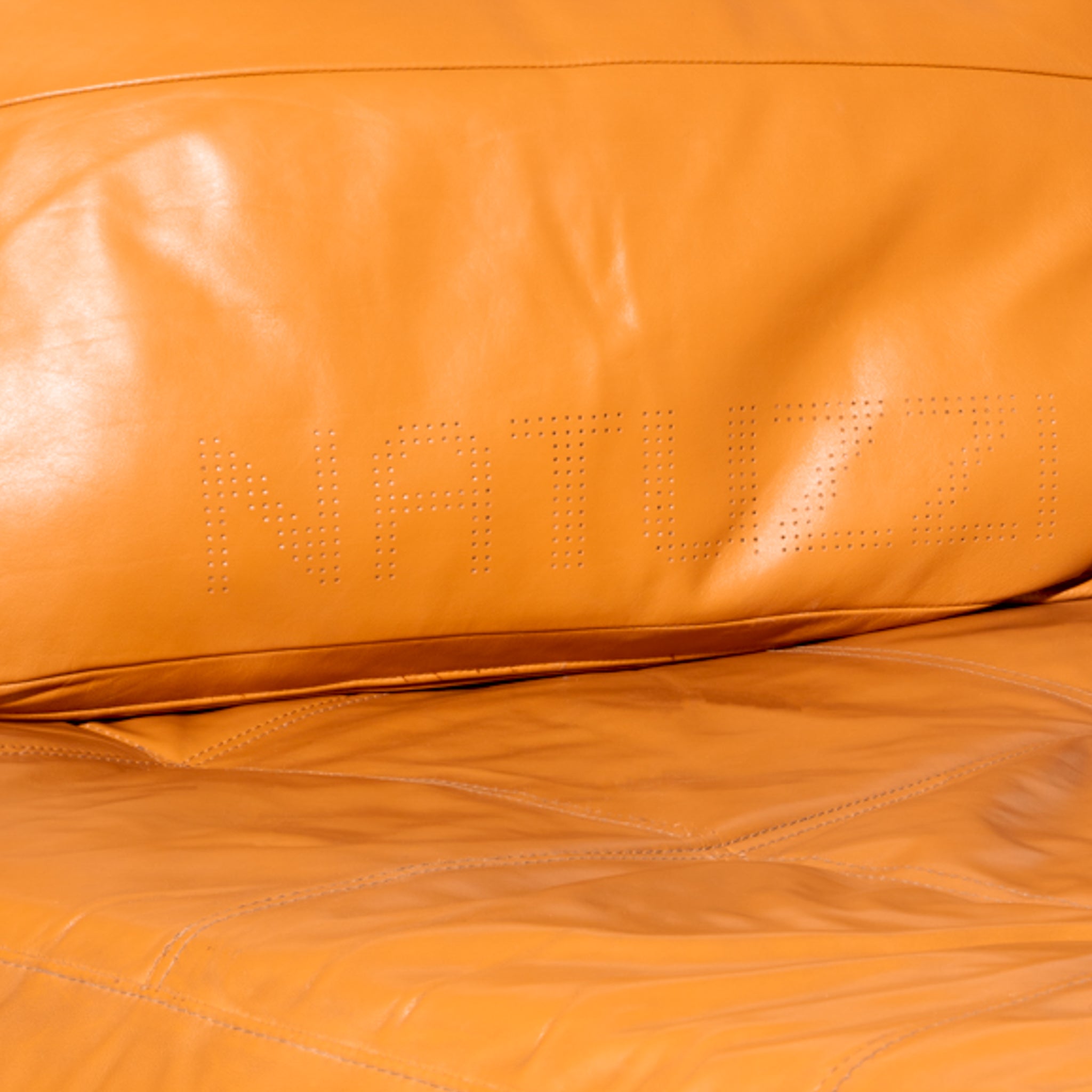 Natuzzi Italian Leather Chaise with perforated logo on the pillow