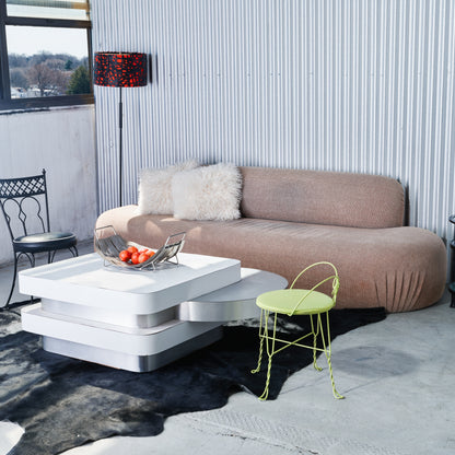 Modern living room with a brown sofa, white coffee table, and a yellow chair.