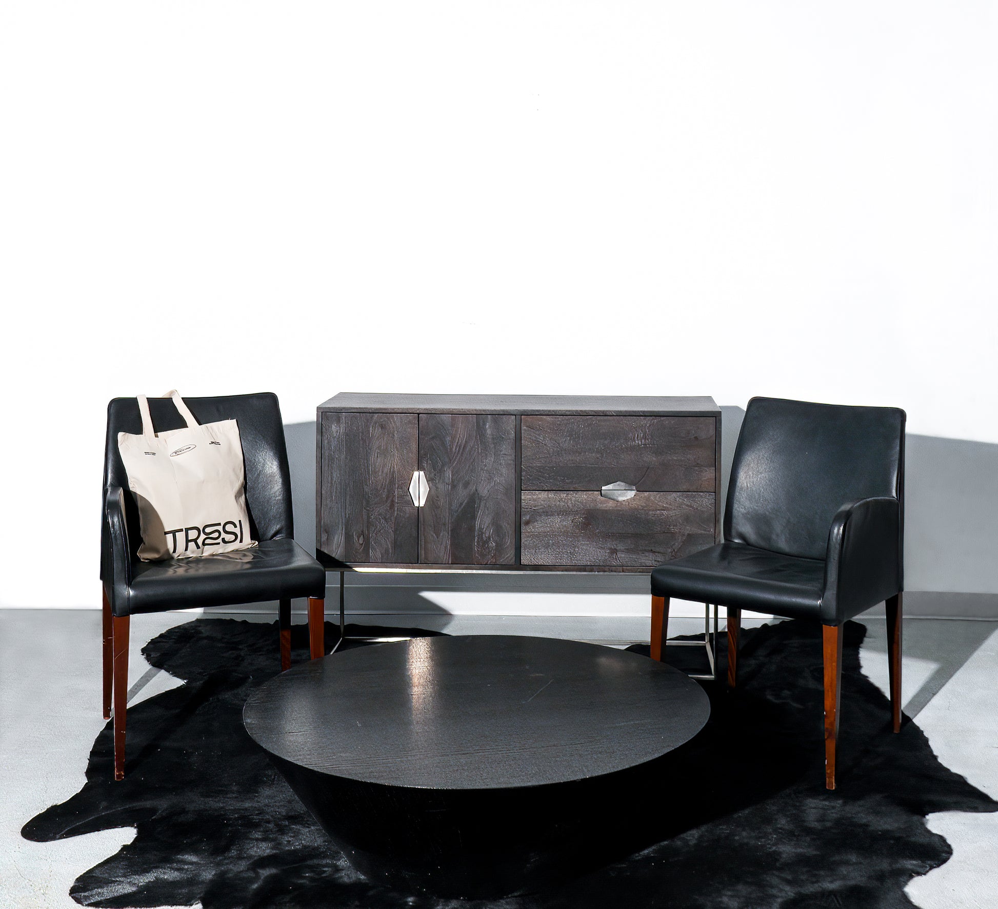 Pair of black leather chairs that converts into a loveseat when placed together